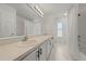 Bathroom featuring double sinks, marble floors, and a shower at 1338 Lake Biscayne Way, Orlando, FL 32824