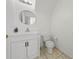 Powder room with decorative mirror, sink, toilet and tile floors at 1338 Lake Biscayne Way, Orlando, FL 32824
