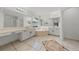 Bright bathroom features a large soaking tub, double sinks, and vanity with large mirrors and tile floors at 1338 Lake Biscayne Way, Orlando, FL 32824