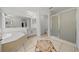 Spacious bathroom featuring a soaking tub, large vanity with mirror, tile floors, and glass shower at 1338 Lake Biscayne Way, Orlando, FL 32824