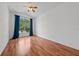 Bedroom with hardwood floors, ceiling fan, and natural light from the window at 1338 Lake Biscayne Way, Orlando, FL 32824