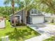 Charming two-story home featuring a well-manicured lawn, lush landscaping, and a two-car garage at 1338 Lake Biscayne Way, Orlando, FL 32824