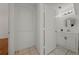 Hallway and doorway leads to powder room with sink and tile floors at 1338 Lake Biscayne Way, Orlando, FL 32824