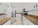 Modern kitchen features white cabinetry, stainless steel appliances, and tile floors at 1338 Lake Biscayne Way, Orlando, FL 32824