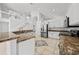 Spacious kitchen with staircase, granite countertops, and stainless steel refrigerator at 1338 Lake Biscayne Way, Orlando, FL 32824