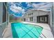 Screened-in pool with a gray house in the background at 1338 Lake Biscayne Way, Orlando, FL 32824
