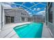 Screened-in pool with a gray house in the background at 1338 Lake Biscayne Way, Orlando, FL 32824
