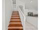 Staircase features wood treads with white risers, and entry way to kitchen at 1338 Lake Biscayne Way, Orlando, FL 32824
