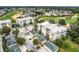 An aerial view highlighting a condo community with garages and lush green golf course surroundings at 1501 Northern Harrier Way # 101, Kissimmee, FL 34747