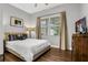 Bedroom featuring a comfortable bed, neutral decor, and natural light from the window at 1501 Northern Harrier Way # 101, Kissimmee, FL 34747