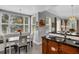 The breakfast nook has a sun-filled window, a table set for four, and an adjacent kitchen at 1501 Northern Harrier Way # 101, Kissimmee, FL 34747