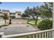 View of the condo building with multiple garage spaces and well-maintained landscaping at 1501 Northern Harrier Way # 101, Kissimmee, FL 34747
