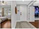 Hallway with tile and wood floors leads to living area and a bedroom with Star Wars themed decor at 1501 Northern Harrier Way # 101, Kissimmee, FL 34747