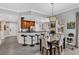 Cozy dining area with a chandelier overlooking the kitchen with modern appliances and counter seating at 1501 Northern Harrier Way # 101, Kissimmee, FL 34747