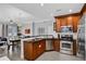 Well-equipped kitchen with stainless steel appliances, counter seating, and a sink at 1501 Northern Harrier Way # 101, Kissimmee, FL 34747