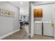 Laundry area with a washer, dryer, and cabinets, seamlessly connected to the home's interior at 1501 Northern Harrier Way # 101, Kissimmee, FL 34747