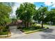 Aerial view of a home with lush landscaping, a two-car garage, and a large driveway at 154 Academy Oaks Pl, Altamonte Springs, FL 32714
