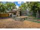 Backyard of home, featuring a pool inside of a screened-in lanai, set in a yard covered in pine straw at 154 Academy Oaks Pl, Altamonte Springs, FL 32714
