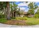 A charming single-Gathering home with manicured landscaping, mature trees, and a curved driveway at 154 Academy Oaks Pl, Altamonte Springs, FL 32714