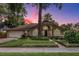 Charming single-story home featuring a manicured lawn, a two-car garage, and a welcoming entrance at 154 Academy Oaks Pl, Altamonte Springs, FL 32714