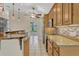 Stylish kitchen featuring granite countertops, wood cabinetry, and a breakfast bar at 154 Academy Oaks Pl, Altamonte Springs, FL 32714