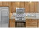 This kitchen features stainless steel appliances and custom wood cabinets at 154 Academy Oaks Pl, Altamonte Springs, FL 32714