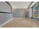 Empty living room featuring tile floors, arched window, neutral walls and sconce lighting at 154 Academy Oaks Pl, Altamonte Springs, FL 32714
