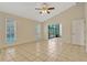 Bright living room with tile floors, large windows and access to sunroom at 154 Academy Oaks Pl, Altamonte Springs, FL 32714