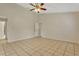 Spacious living room with tile floors, ceiling fan and two entry doors at 154 Academy Oaks Pl, Altamonte Springs, FL 32714