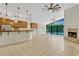 Bright living room with fireplace, tiled floors, and large windows overlooking the pool area at 154 Academy Oaks Pl, Altamonte Springs, FL 32714