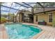 Screened-in pool area with brick pavers, offering a backyard view and access to the home's interior at 154 Academy Oaks Pl, Altamonte Springs, FL 32714