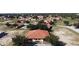 Aerial view showcasing lush landscaping, and nearby homes and businesses in a well-maintained community at 1558 Cumin Dr, Poinciana, FL 34759