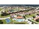 Stunning aerial shot of the community featuring a pool, clubhouse, tennis court, and beautifully maintained grounds at 1558 Cumin Dr, Poinciana, FL 34759
