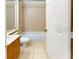 Bathroom featuring a bath and shower combination, tiled walls and vanity at 1558 Cumin Dr, Poinciana, FL 34759