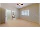 Spacious bedroom with tile floors, ceiling fan and natural light with a bathroom doorway at 1558 Cumin Dr, Poinciana, FL 34759