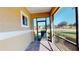 Screened outdoor patio area with sunny view looking out onto grass, trees, and neighborhood at 1558 Cumin Dr, Poinciana, FL 34759