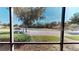 Property view through windows featuring trees, grass, and surrounding scenery under a sunny sky at 1558 Cumin Dr, Poinciana, FL 34759