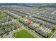 Expansive aerial view of a well-planned community featuring townhomes, green spaces and neatly paved streets at 1818 Katz Crossing Dr, Kissimmee, FL 34744