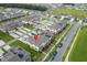 Aerial view of townhomes featuring solar panels and private driveways in a vibrant community at 1818 Katz Crossing Dr, Kissimmee, FL 34744