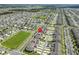 Aerial view of a residential community showcasing townhomes, green spaces, and well-organized street layouts at 1818 Katz Crossing Dr, Kissimmee, FL 34744