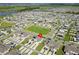 Residential aerial view displaying townhomes, solar panels, nearby green areas, and a picturesque lake at 1818 Katz Crossing Dr, Kissimmee, FL 34744