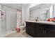 Bathroom featuring a shower, dual sinks, and tile floors at 1818 Katz Crossing Dr, Kissimmee, FL 34744