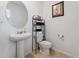 Simple half-bath with pedestal sink, toilet, and neutral color scheme at 1818 Katz Crossing Dr, Kissimmee, FL 34744