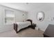 Cozy carpeted bedroom with a twin bed, a window with blinds, and neutral decor at 1818 Katz Crossing Dr, Kissimmee, FL 34744