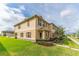 Charming townhome exterior with lush green lawn and inviting curb appeal at 1818 Katz Crossing Dr, Kissimmee, FL 34744
