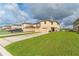 Attractive two-story home with a spacious driveway and well-manicured front lawn at 1818 Katz Crossing Dr, Kissimmee, FL 34744