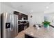 Well-equipped kitchen with stainless steel refrigerator and sleek countertops at 1818 Katz Crossing Dr, Kissimmee, FL 34744