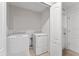 Efficient laundry room featuring a washer and dryer, with convenient access to nearby spaces at 1818 Katz Crossing Dr, Kissimmee, FL 34744