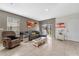 Bright living room features tiled floors, comfortable seating, and sliding glass door to the backyard at 1818 Katz Crossing Dr, Kissimmee, FL 34744