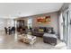 Open living and dining area featuring tiled floors, a comfortable sofa, and sliding door to the backyard at 1818 Katz Crossing Dr, Kissimmee, FL 34744